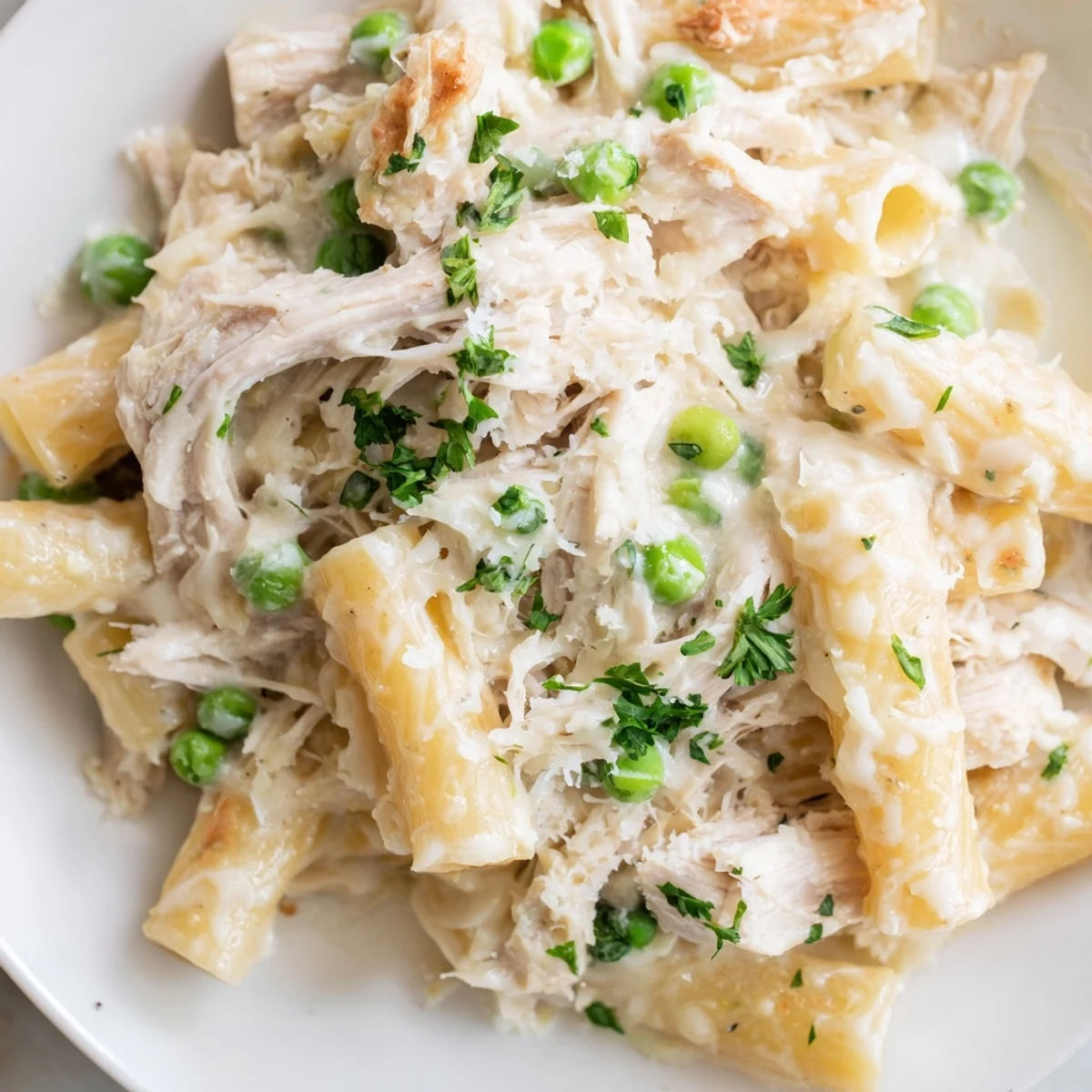 Creamy Slow Cooker Chicken Alfredo Pasta Bake with perfectly tender chicken, rich sauce, and melted cheese.
