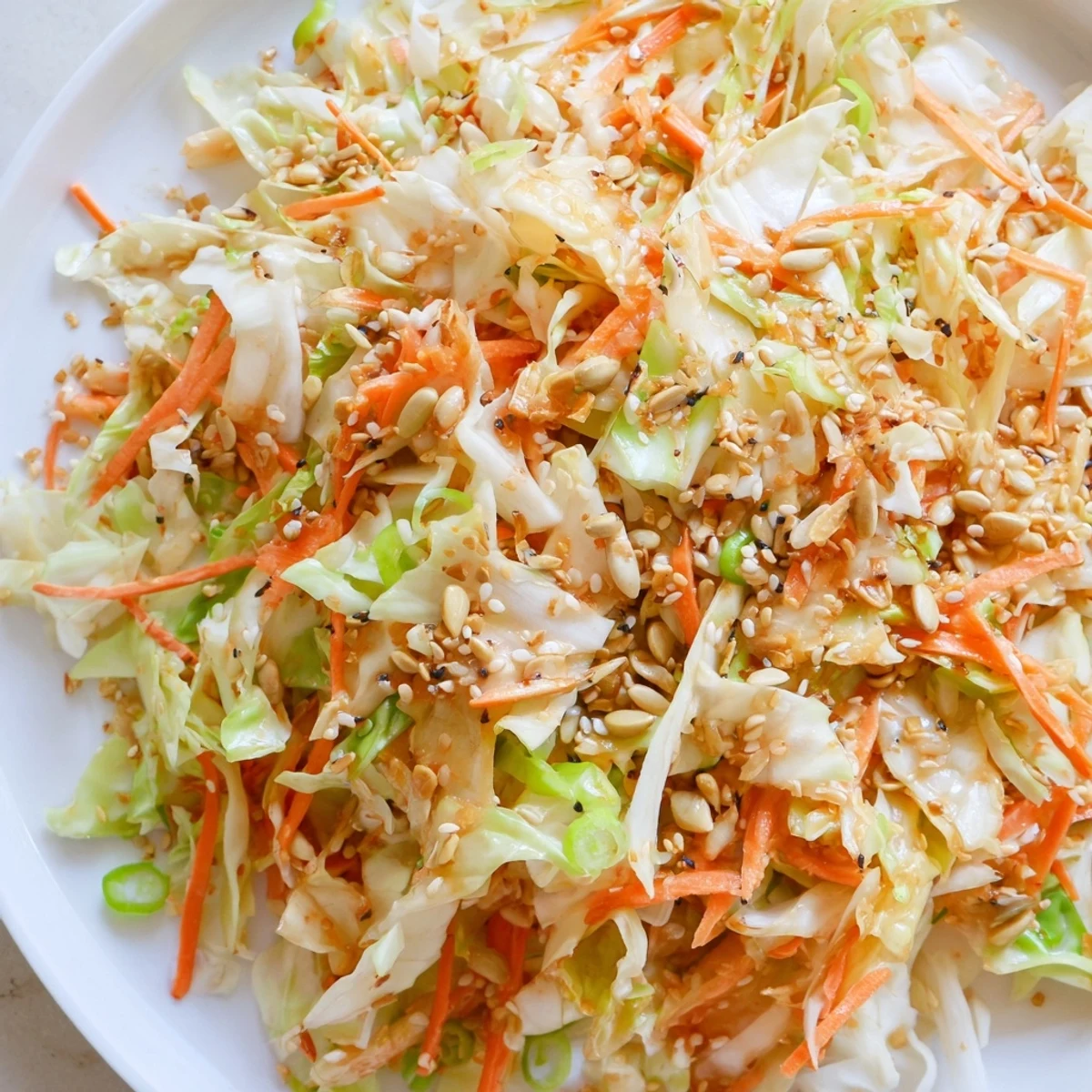 Crisp Cabbage-Core Slaw Salad, a vibrant mix with toasted seeds and a tangy sesame dressing.