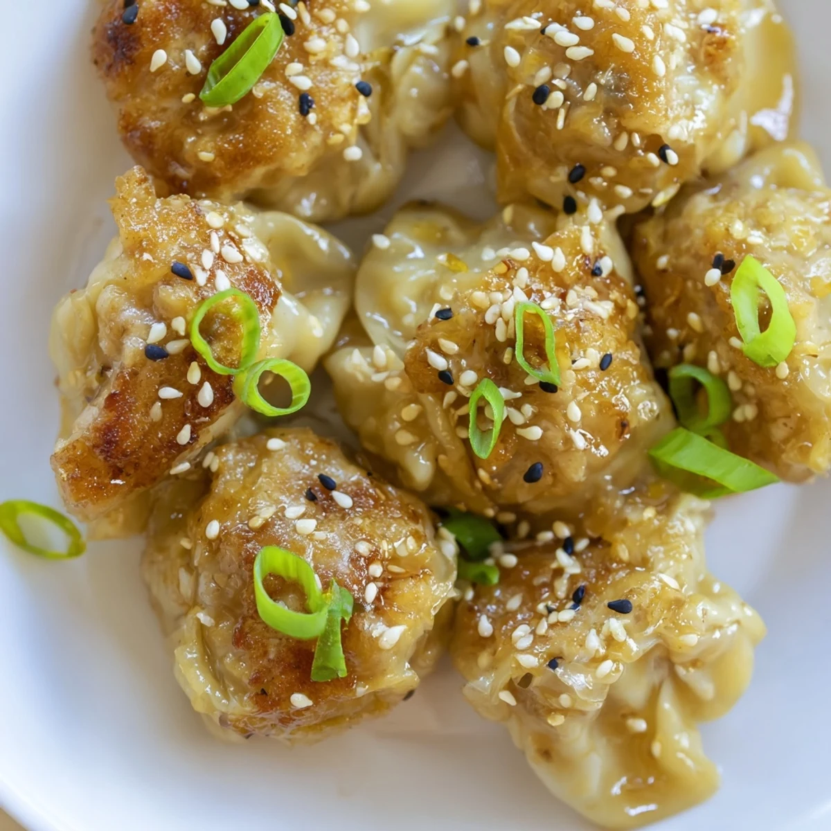 These hot and savory Air Fryer Frozen Dumplings are pictured with a sesame seed garnish, perfect snack.
