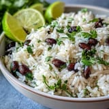 Fluffy Coconut Lime Rice, garnished with fresh cilantro and hearty black beans.