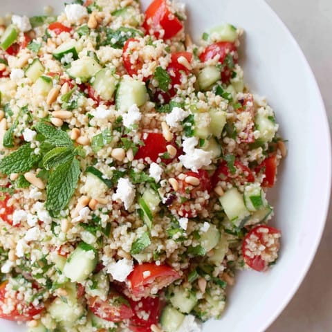 Fresh, flavorful Tabbouleh Grain Bowl, drizzled with lemon dressing, ready for a delicious vegetarian meal.