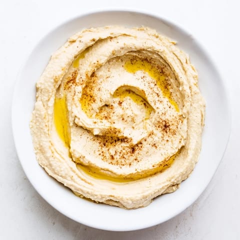 Colorful Middle Eastern Mezze Platter with feta cheese, pita triangles, and crisp veggies arranged for sharing.  