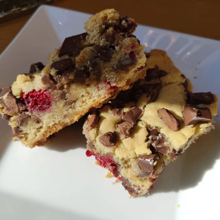 Fresh raspberries and melted white chocolate mingle within these soft, irresistible blondies.