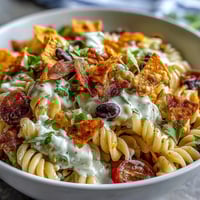 Taco Pasta Salad with Doritos and Avocado Ranch, loaded with colorful veggies and creamy dressing.  